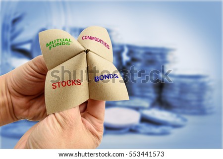 Man uses a paper fortune teller to make multiple decisions for his own portfolio, allocating assets and diversifying in a portfolio to minimize risk for optimal profits. Financial investment concept.