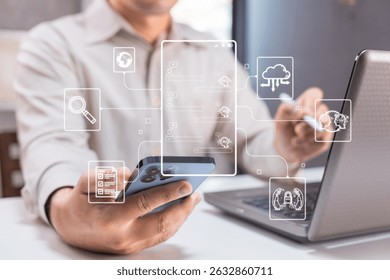 A man uses a smartphone and laptop with digital cloud computing icons overlaying the image, symbolizing modern technology and connectivity.
