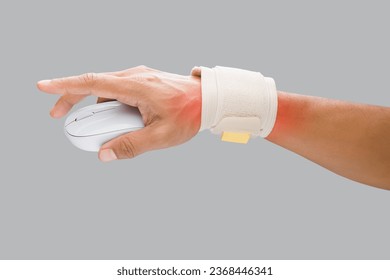 The man uses a wrist restraint to support his wrist and prevent pain while using the mouse during work. - Powered by Shutterstock