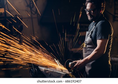 man using angle grinder sparks