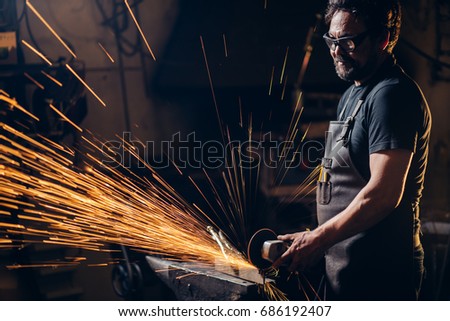 man using angle grinder sparks