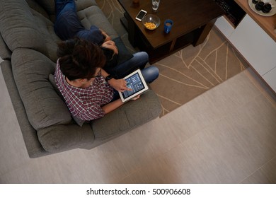 Man using application on tablet to control smart home