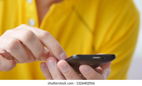 A man using apps on a mobile touchscreen smartphone. Concept of modern technology, shopping online and smart phones