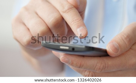 A man using apps on a mobile touchscreen smartphone. Concept of modern technology, shopping online and smart phones
