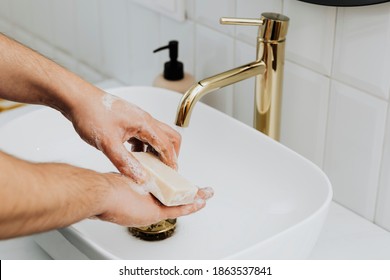 Man Using A Bar Soap To Wash His Hands