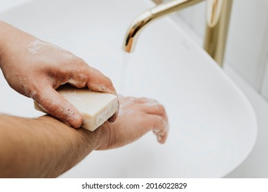 Man Using A Bar Soap To Wash His Hands