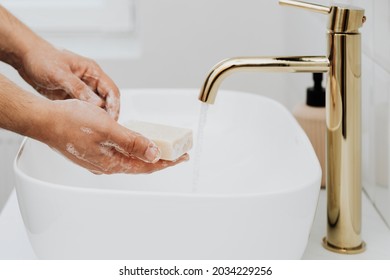 Man Using A Bar Soap To Wash His Hands