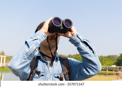 Man Using Binoculars For Birdwatching