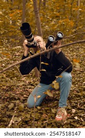 Man using binoculars and camera for birdwatching and other observing animals in nature.
