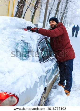 Similar – Image, Stock Photo A man clears snow from a street with a snow shovel
