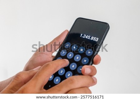 A man using a calculator app on a smartphone
