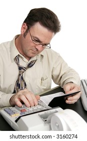 A Man Using A Calculator To Balance His Checkbook.  Isolated On White.