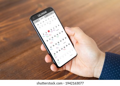 Man using calendar app on mobile phone