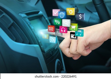 Man Using Car Audio Stereo System And Pushing On Car Screen Interface, With Driver Entering Cloud Of Colorful Application Icon Social Media Networking Transportation And Vehicle Concept Idea