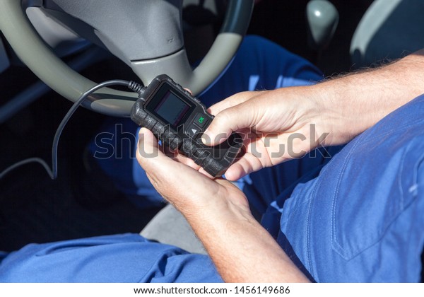 Man using car diagnostic\
scan tool