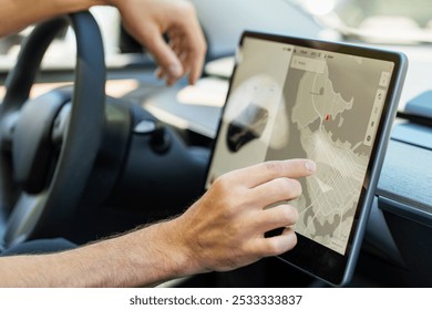 Man using car navigation system on large screen for efficient driving experience. Smart vehicle with advanced technology for seamless city navigation