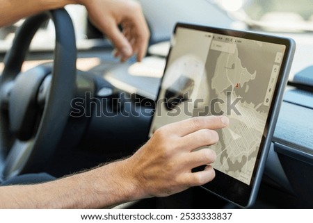 Man using car navigation system on large screen for efficient driving experience. Smart vehicle with advanced technology for seamless city navigation