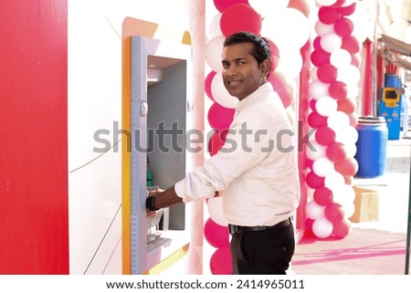 Man using card at an ATM