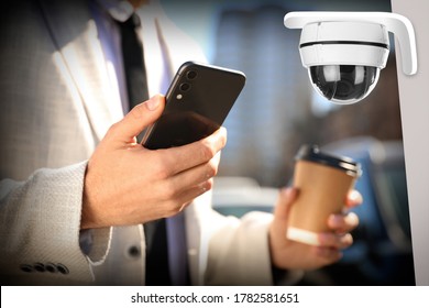 Man using CCTV app on smartphone outdoors, closeup
