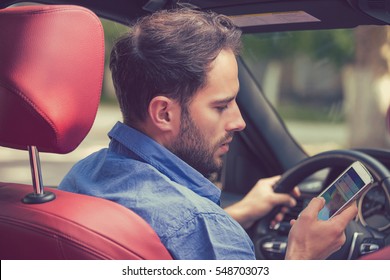 Man Using Cell Phone Texting While Driving. Risky, Reckless Driver Concept 