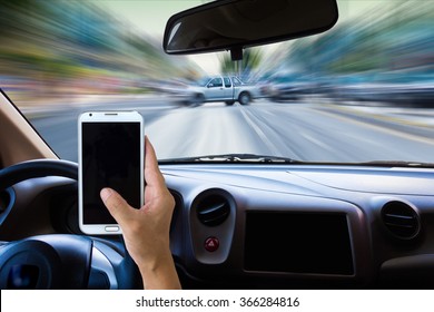 Man Using Cell Phone While Driving .