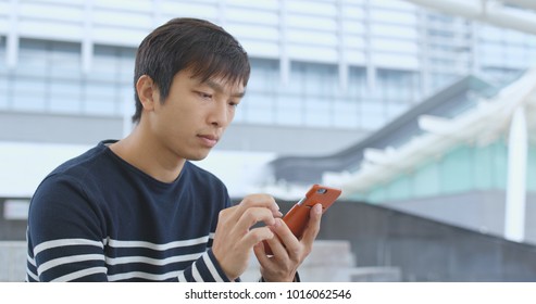 Man using cellphone at outdoor 