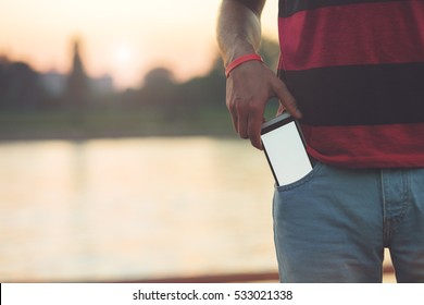 Man using cellphone outdoors.

