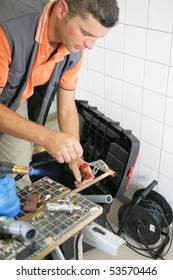 Man Using A Combination Pliers