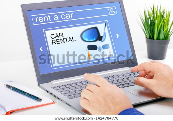 Man using\
a computer with car rental concept on the screen. Car Rental\
Transportation Logistics Selection Man\
Working.