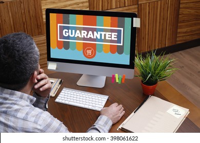 Man using computer with GUARANTEE concept on screen
