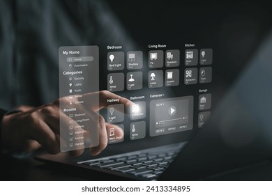 Man using computer laptop to manage smart home application for control home appliances. Smart intelligence dashboard to connect IoT devices for automation. Assistant house technology management. - Powered by Shutterstock