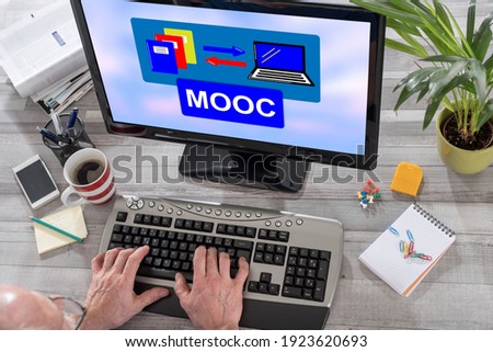 Man using a computer with mooc concept on the screen