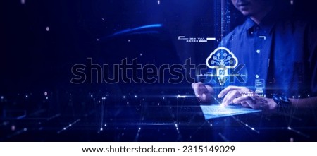 Man using computer to upload data to secure and privacy protected storage on cloud technology or edge computing. Artificial intelligence innovation helps system development on a blue background.