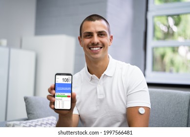 Man Using Continuous Glucose Remote Monitor Diabetes Sensor