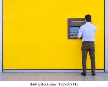 Man Using A Credit Card In An Atm For Cash Withdrawal