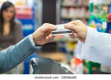 Man Using A Credit Card To Pay In A Grocery Store