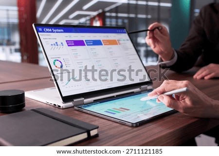 Man Using CRM Software On Laptop To Support Global Sales.