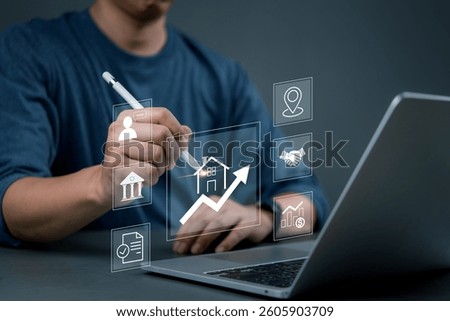 Man using digital pen to visualize real estate market trends, drawing growth charts and financial graphs, business strategy, and property investment analysis.
