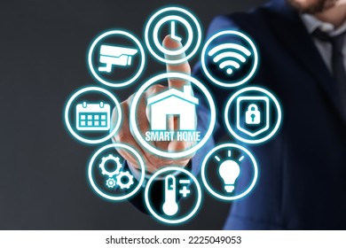 Man using digital screen with Smart Home interface on dark grey background, closeup