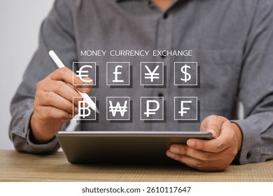 Man using a digital tablet with currency exchange icons overlay, representing global financial transactions and technology-driven markets.