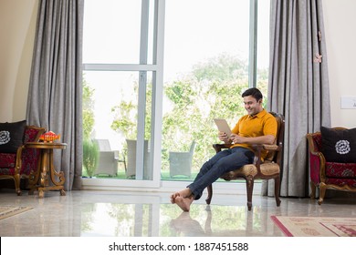 Man Using Digital Tablet At Home