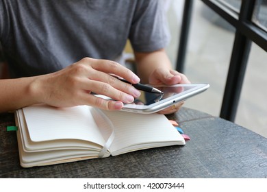 man using the digital tablet and phone working in living room,  Internet of things lifestyle with wireless communication and internet with smartphone.