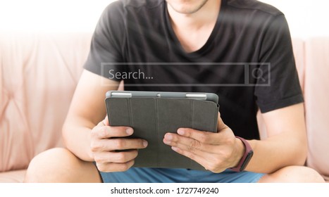 man using digital tablet while relaxing on sofa. Concept of young business people work from home. Man searching data online. stay at home concept