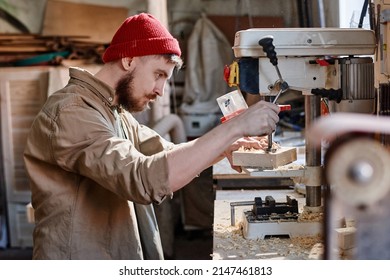 Man Using Drill Press In Workshop - Powered by Shutterstock