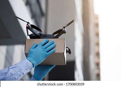 Man Using Drone For Fast Delivery Of Package With Products, Safety Delivery On Quarantine, Copy Space