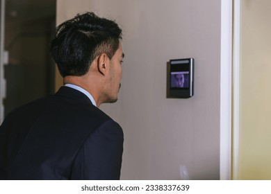 Man using face scanner to unlock door in office building. Access control facial recognition system. Biometric admittance control device for security system. Biometric admittance control device