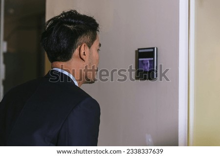 Man using face scanner to unlock door in office building. Access control facial recognition system. Biometric admittance control device for security system. Biometric admittance control device