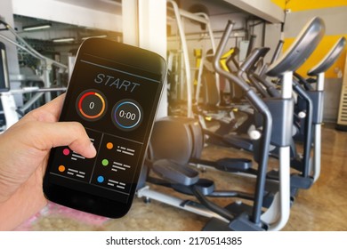 Man Using Fitness Tracker App On Smartphone with sunshine in blur Gym background. - Shutterstock ID 2170514385