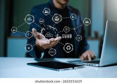 Man using futuristic interface with smart tech and mobile to manage ESG, clean energy, and sustainability data in office	