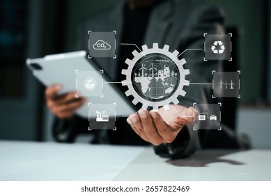 Man using futuristic interface with smart tech and mobile to manage ESG, clean energy, and sustainability data. in office	